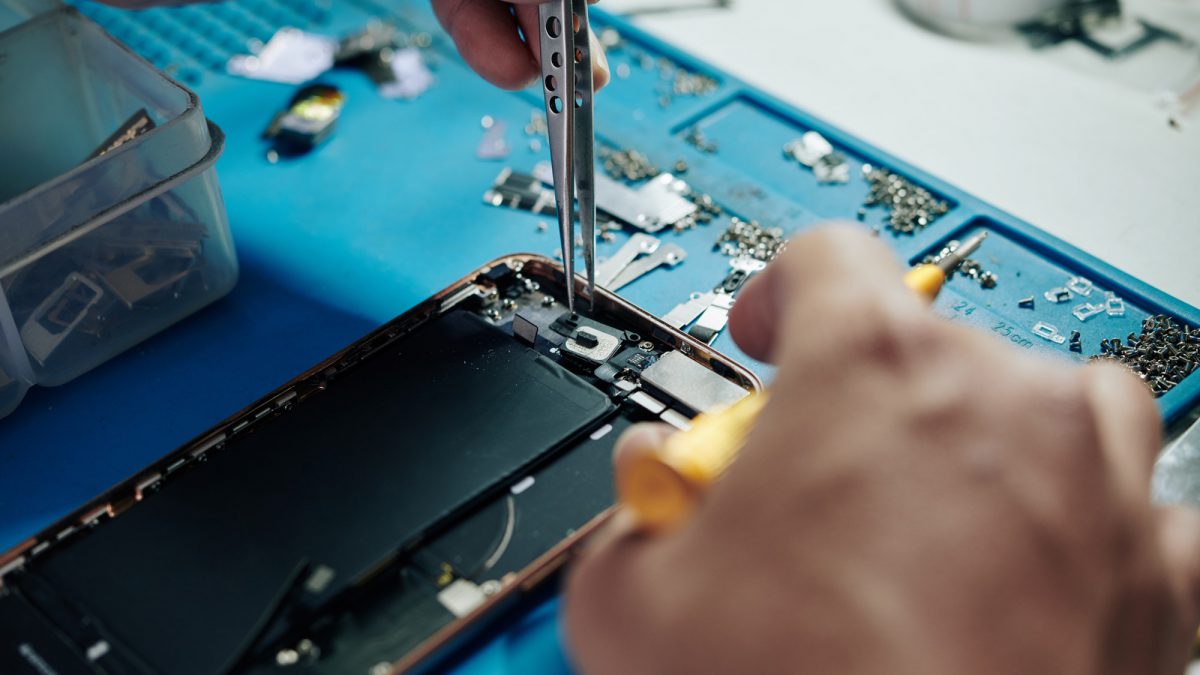 Repairman fixing smartphone camera