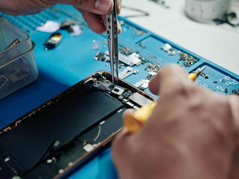 Repairman fixing smartphone camera